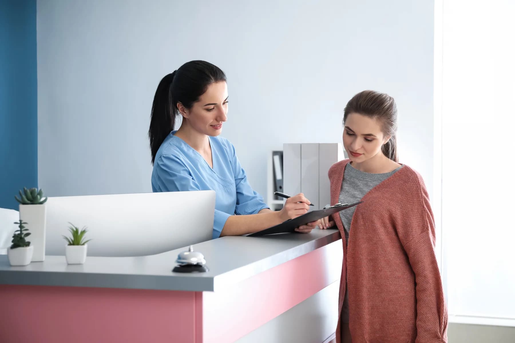 A patient and team member at a dental reception