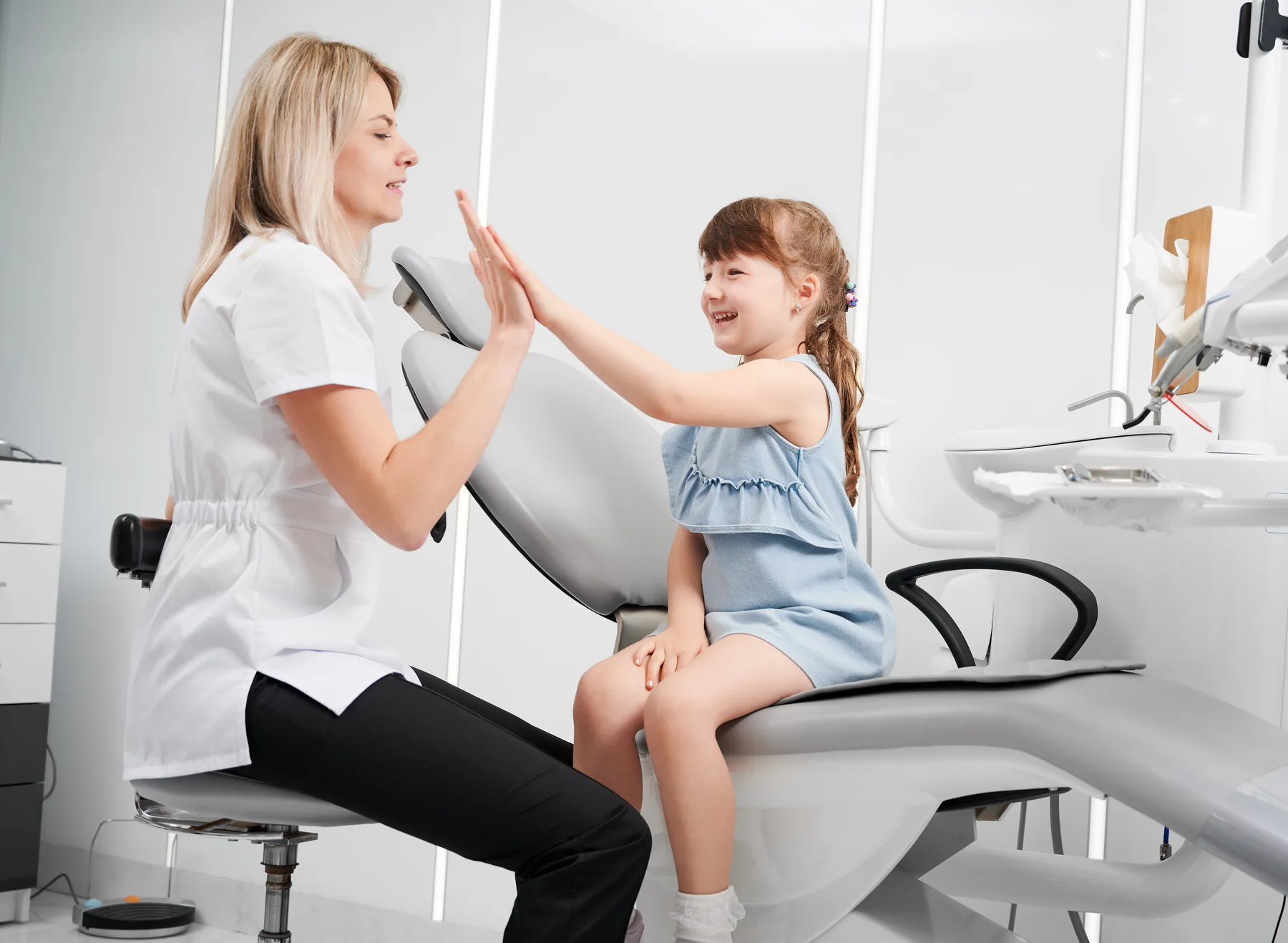 A child giving a dentist a high five