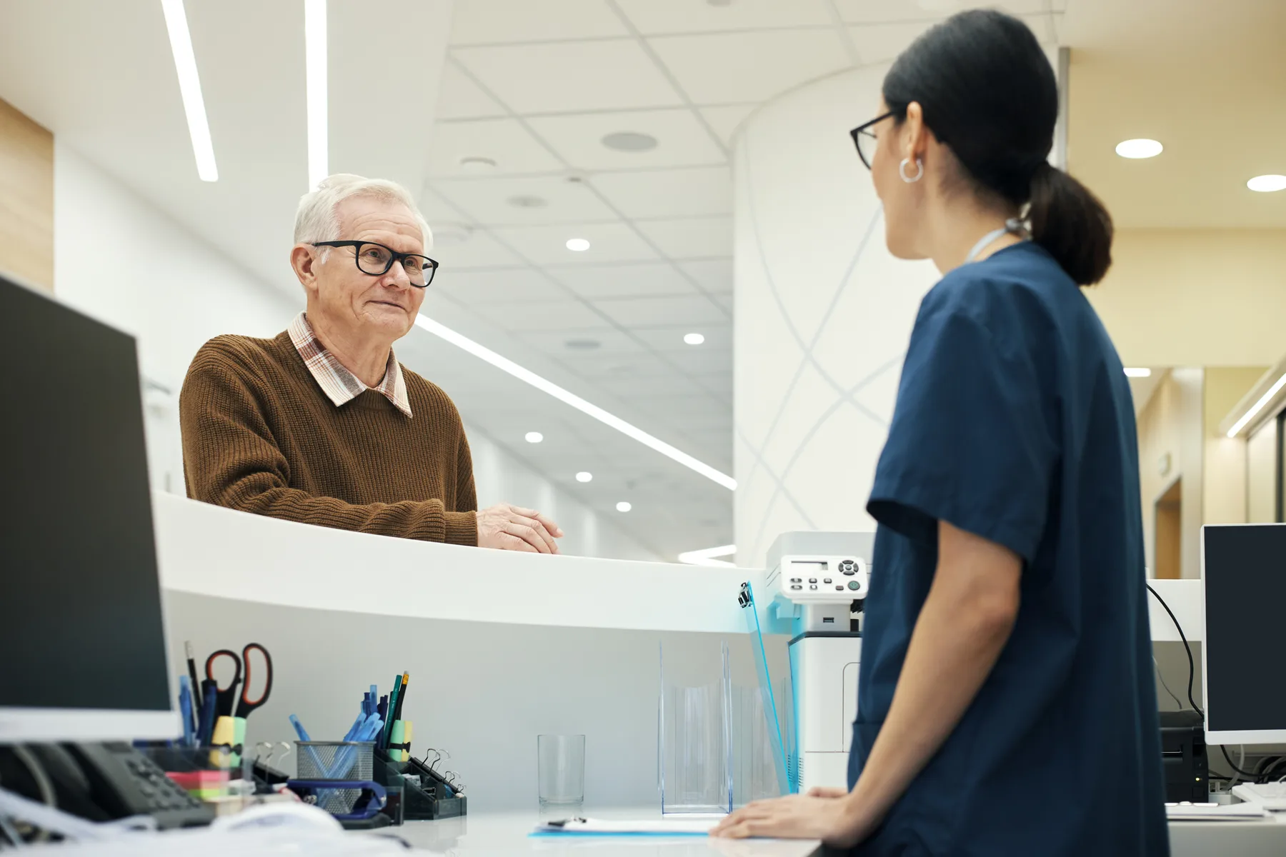 A patient speaking with a member of the dental team