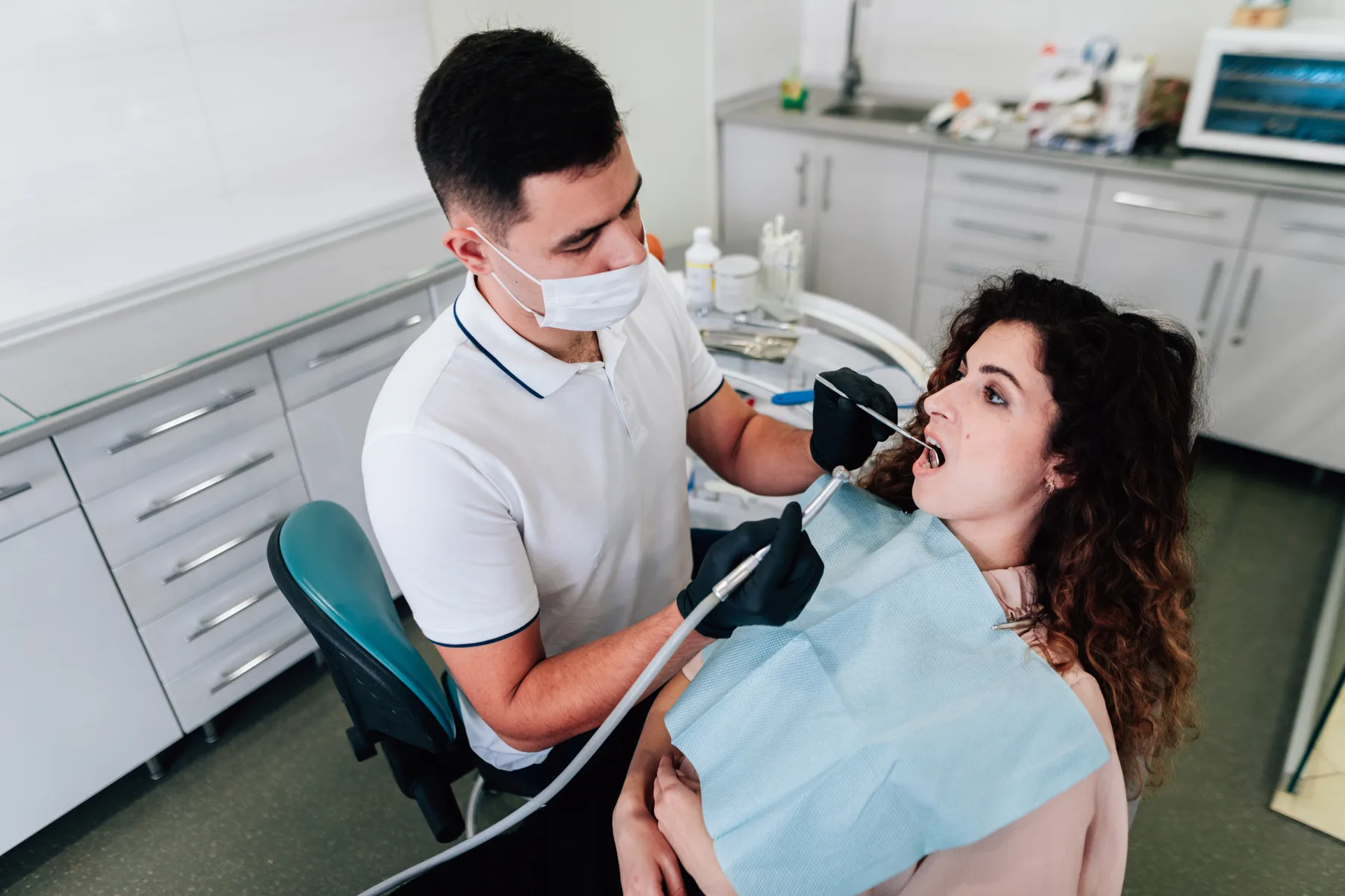 A dentist examining a patient’s teeth