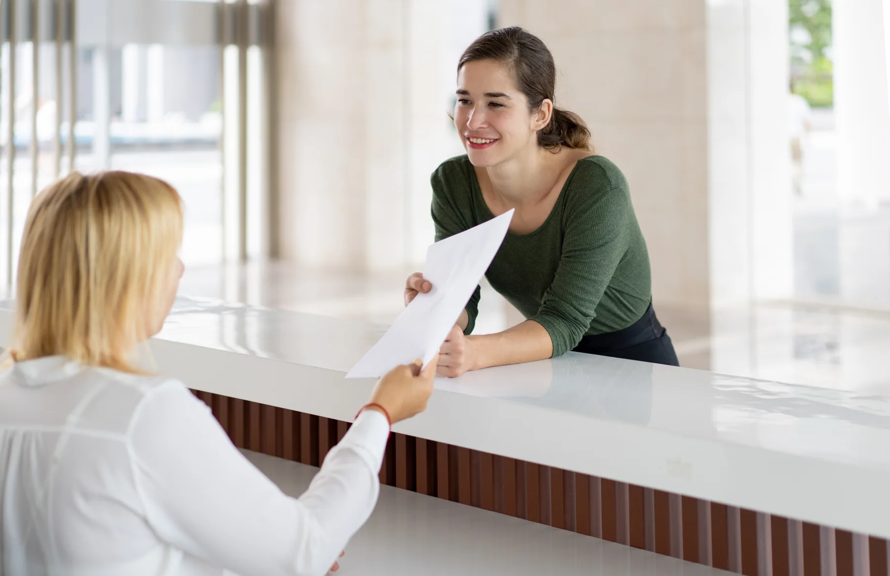 A patient and team member at a dental reception