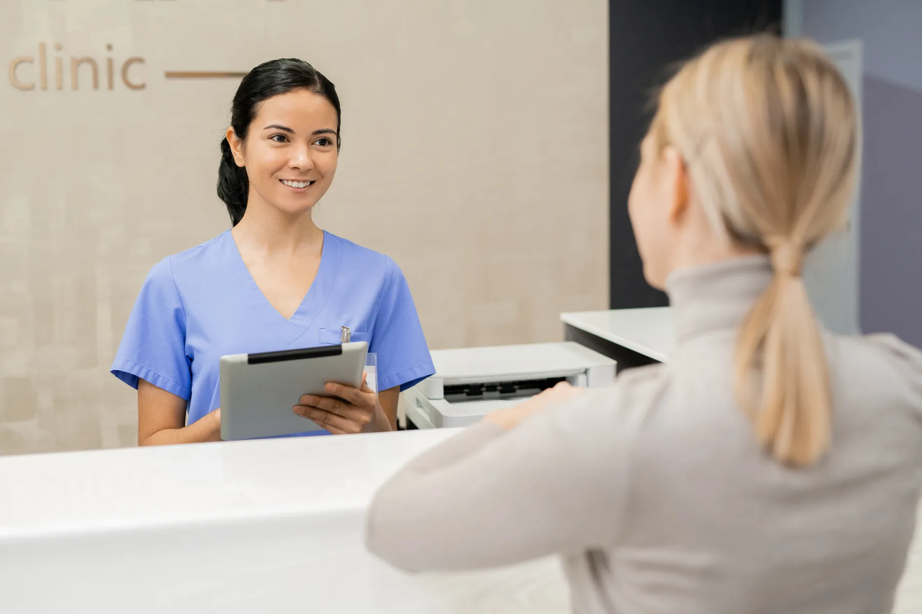 A patient and team member at a dental reception