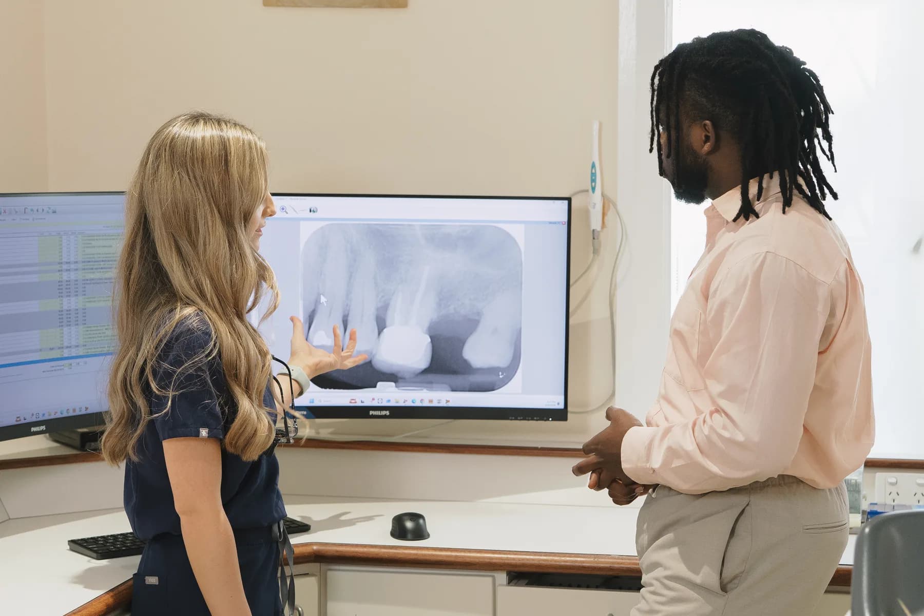 A dentist explaining an X-ray at Absolute Dental