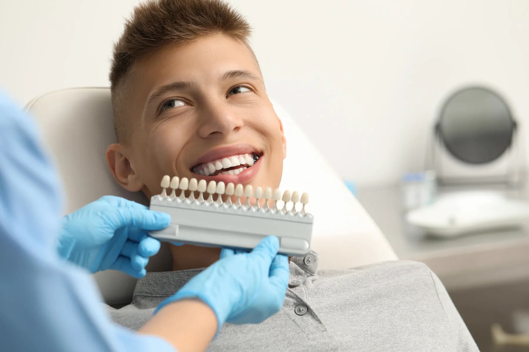 A patient discussing a shade guide with a dentist