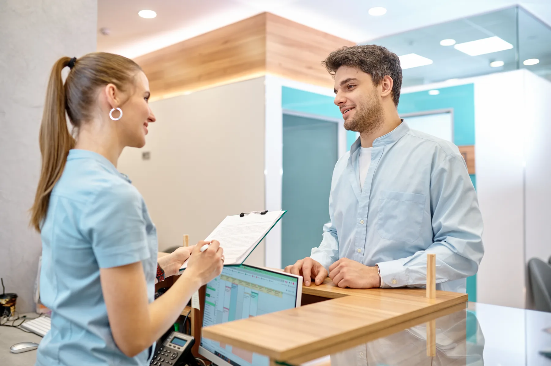 A patient and team member at a dental reception