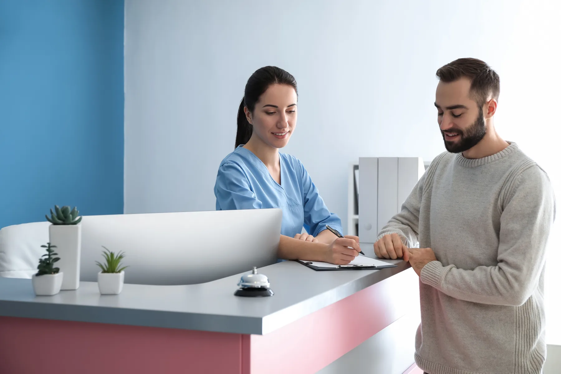 A patient paying by card at a dental reception