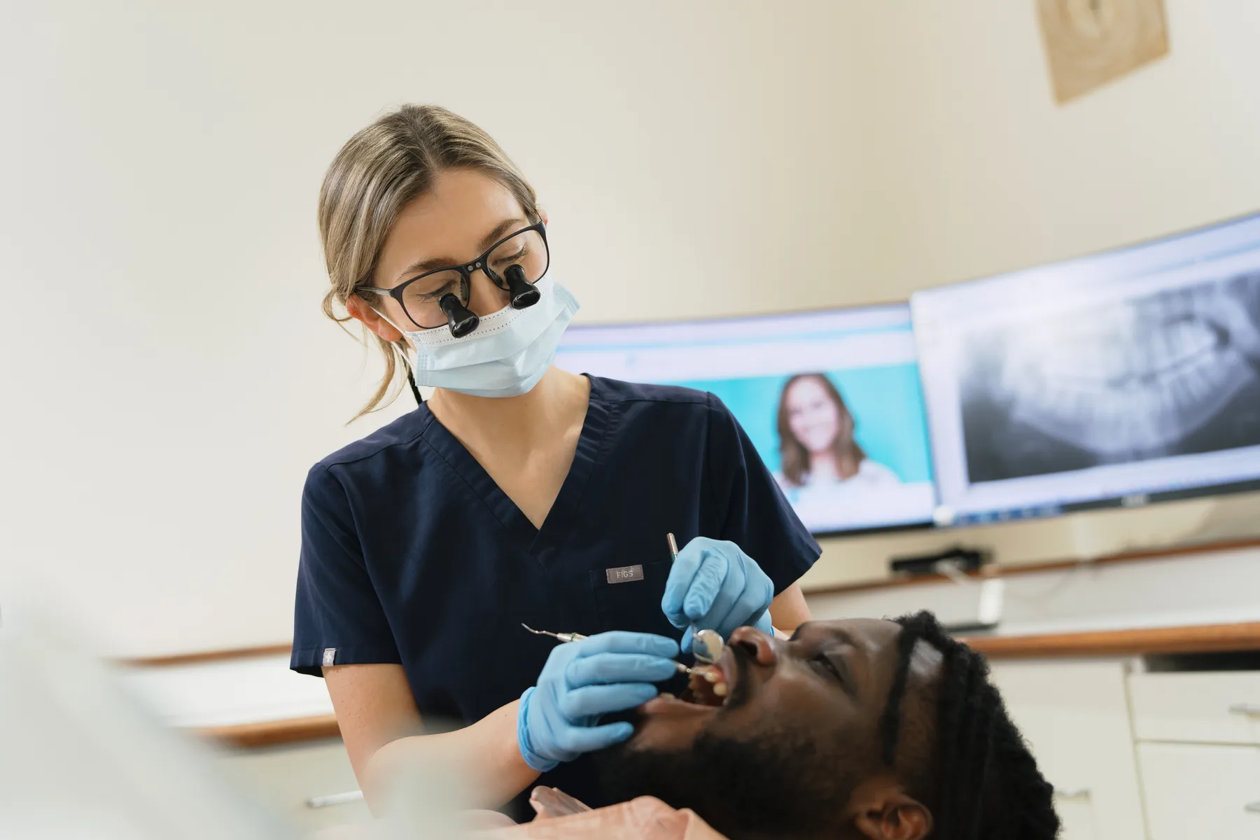 A dentist examining a patient at Absolute Dental
