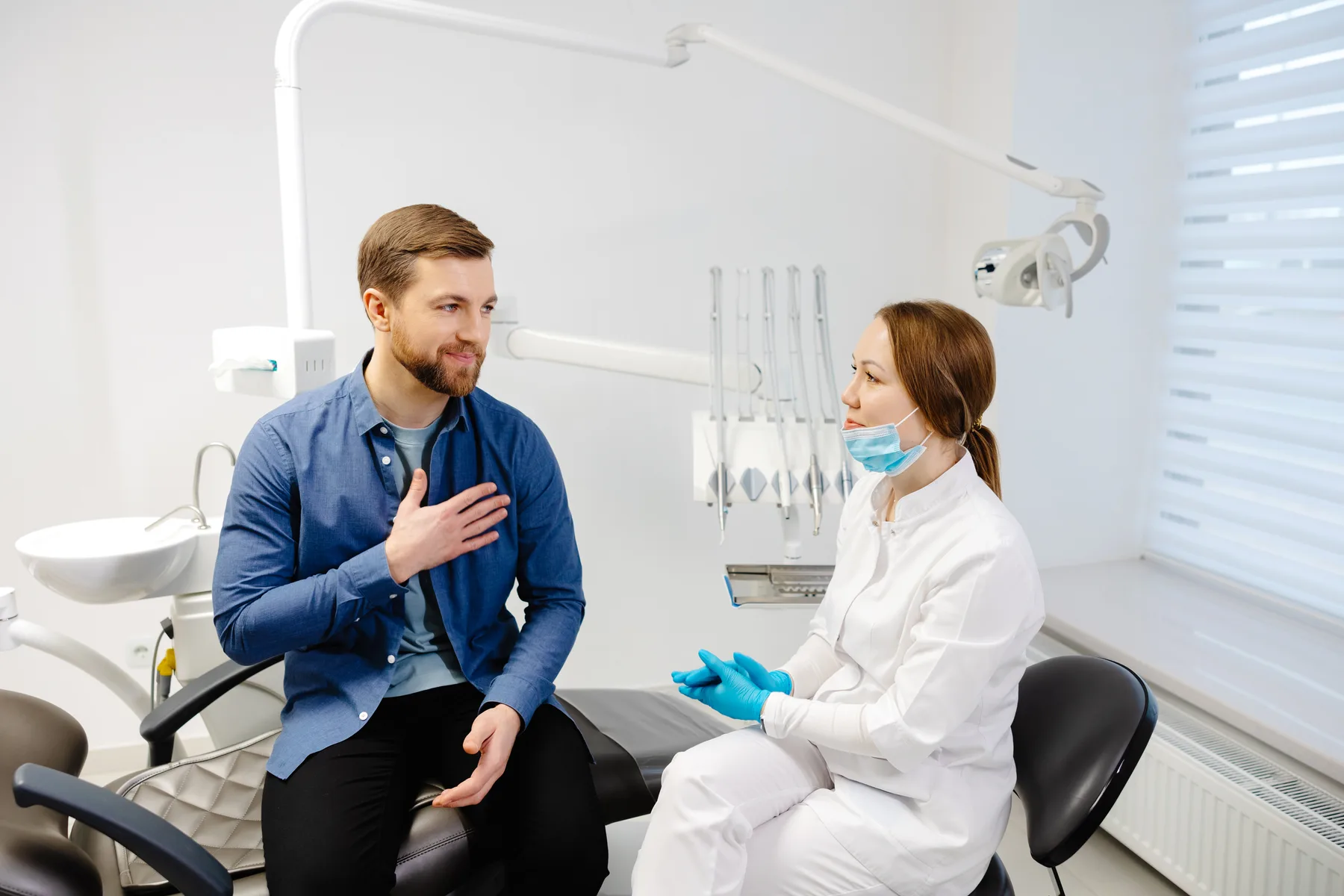 A patient discussing concerns with a dentist